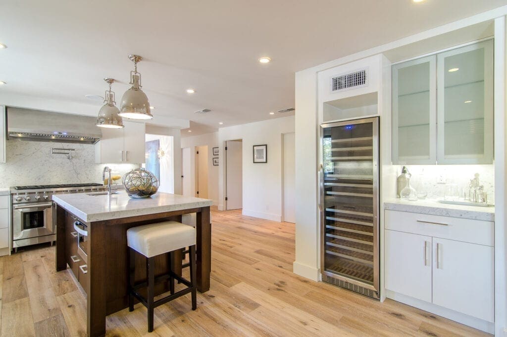 A kitchen with wooden floors and white walls.