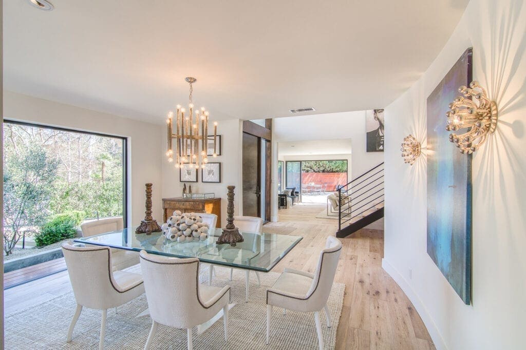 A dining room with glass table and chairs
