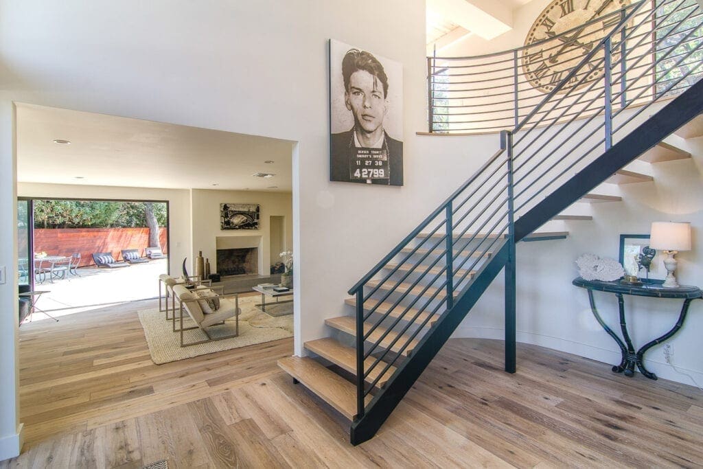 A staircase with metal railing and wood steps.