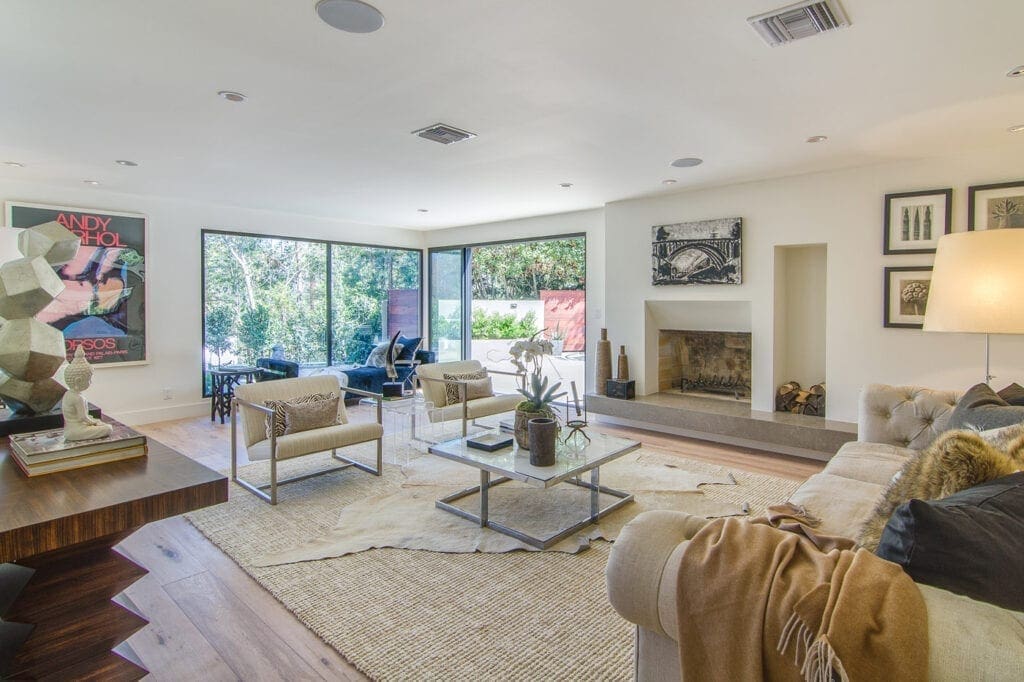 A living room with couches, chairs and tables.