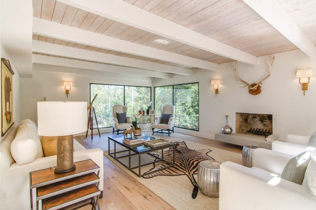 A living room with white walls and wooden floors.