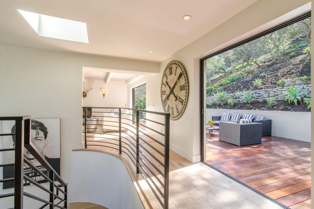 A large clock is on the wall of this house.