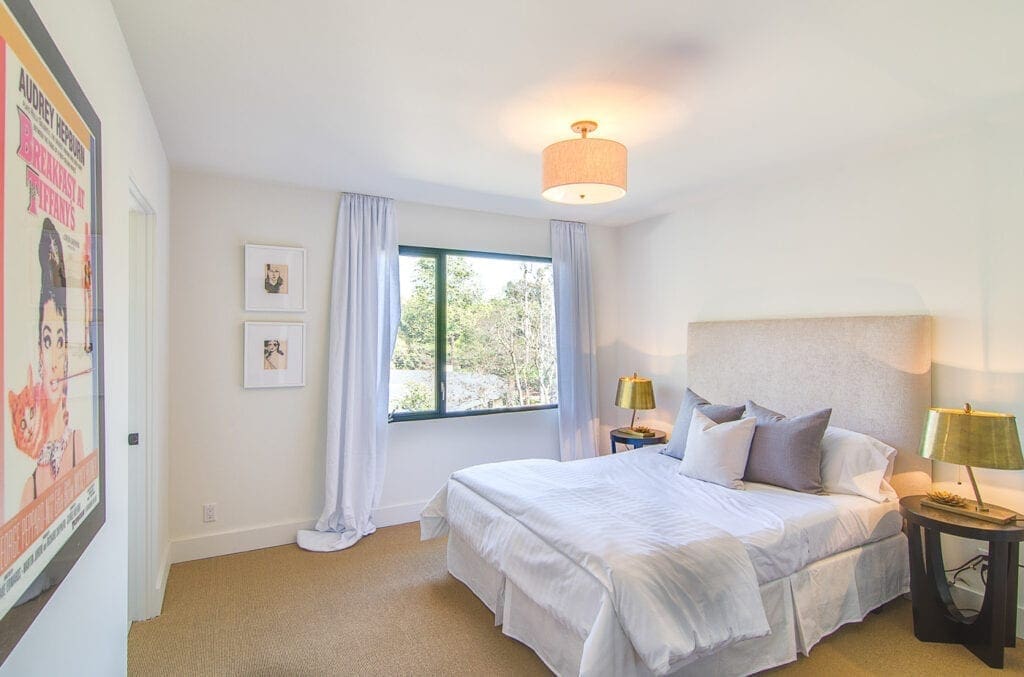 A bedroom with white walls and a large bed.