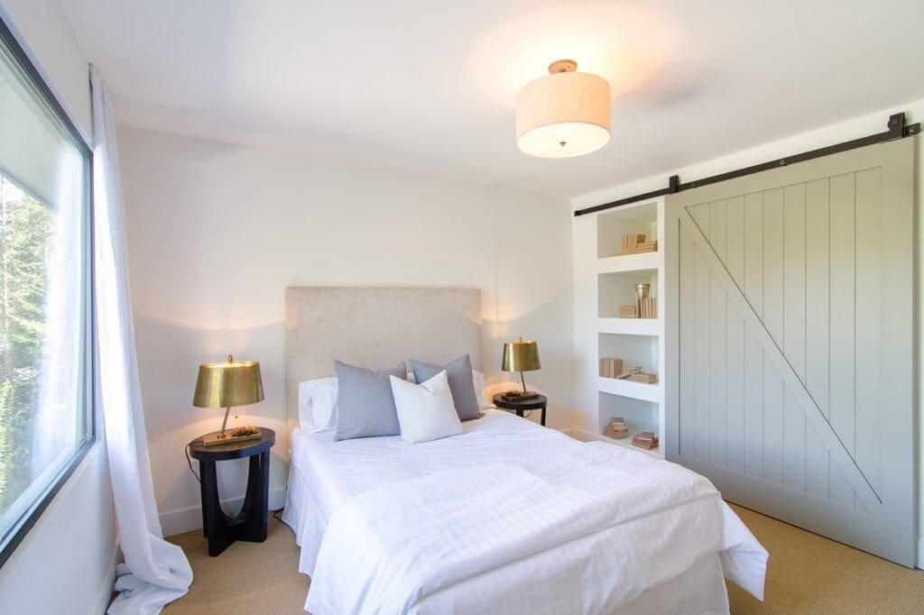 A bedroom with white walls and a large bed.