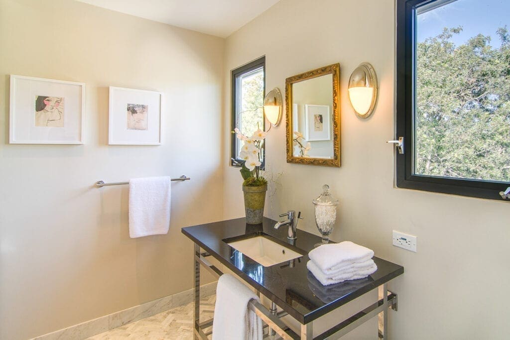 A bathroom with a sink and mirror in it