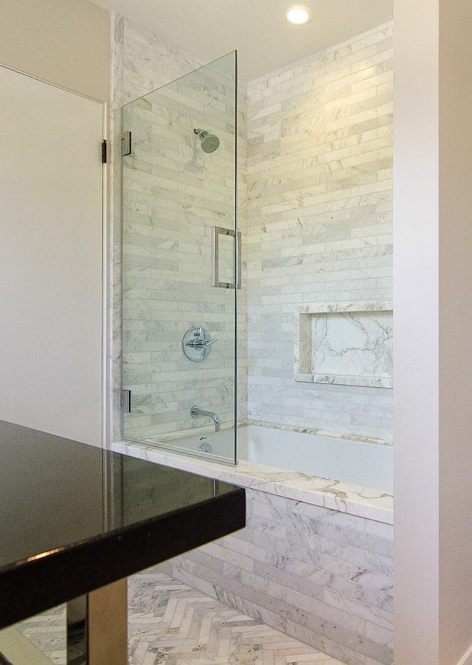 A bathroom with marble walls and floors