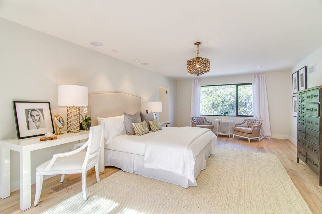 A bedroom with two beds and a desk in it