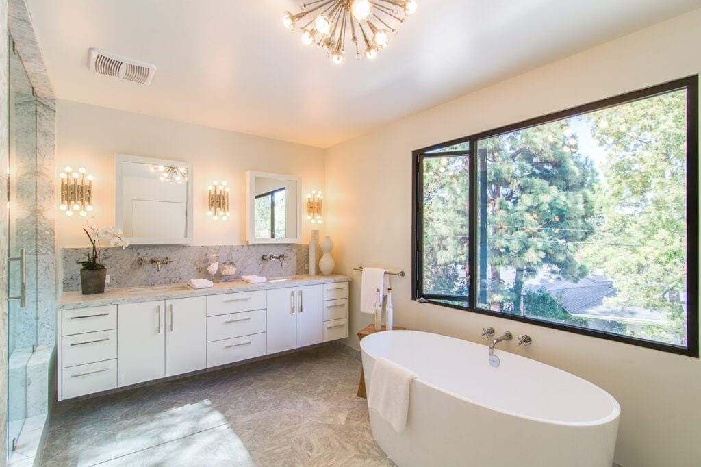 A bathroom with a large tub and sink.