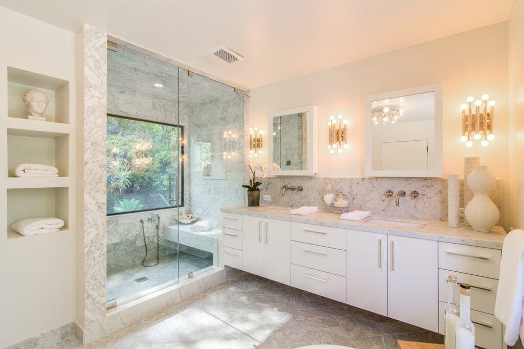 A bathroom with two sinks and a large mirror.