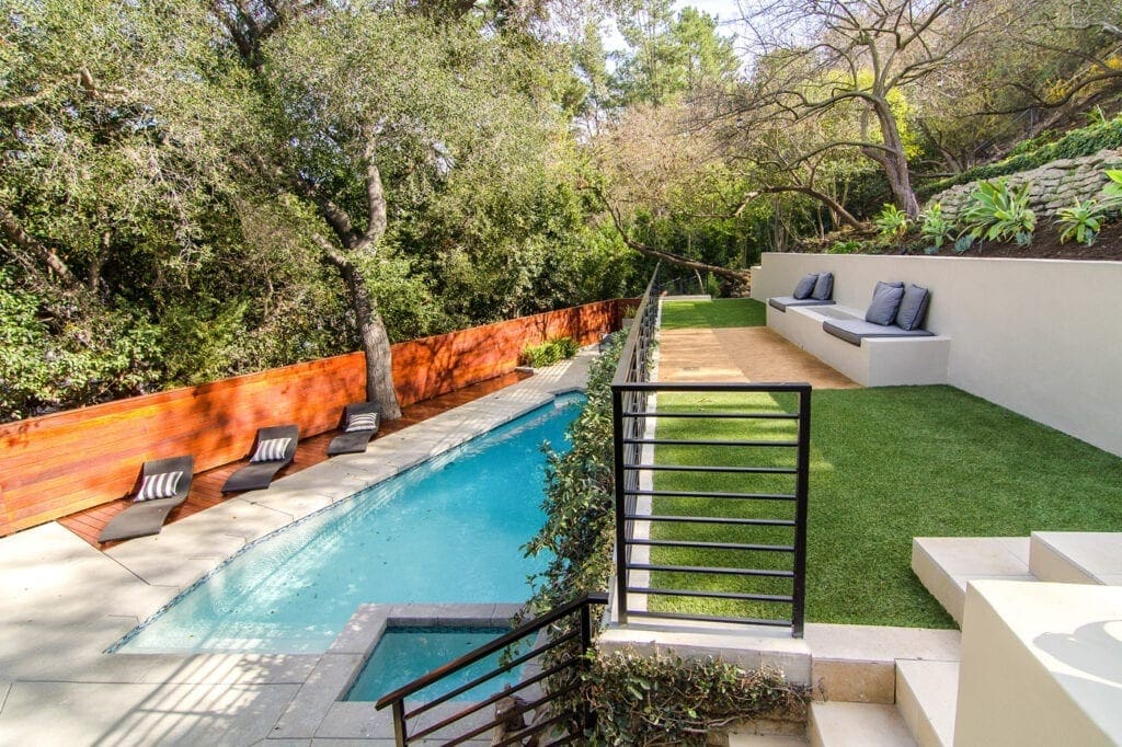 A pool with stairs leading to the side of it.