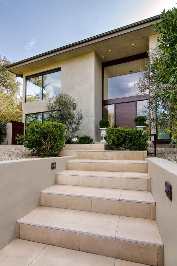 A house with steps leading to the front door.
