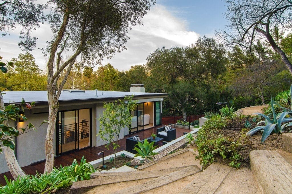 A house with a garden and trees in the background