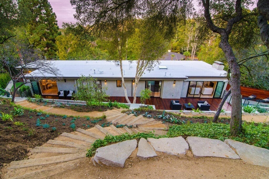 A house with steps leading to the front yard.