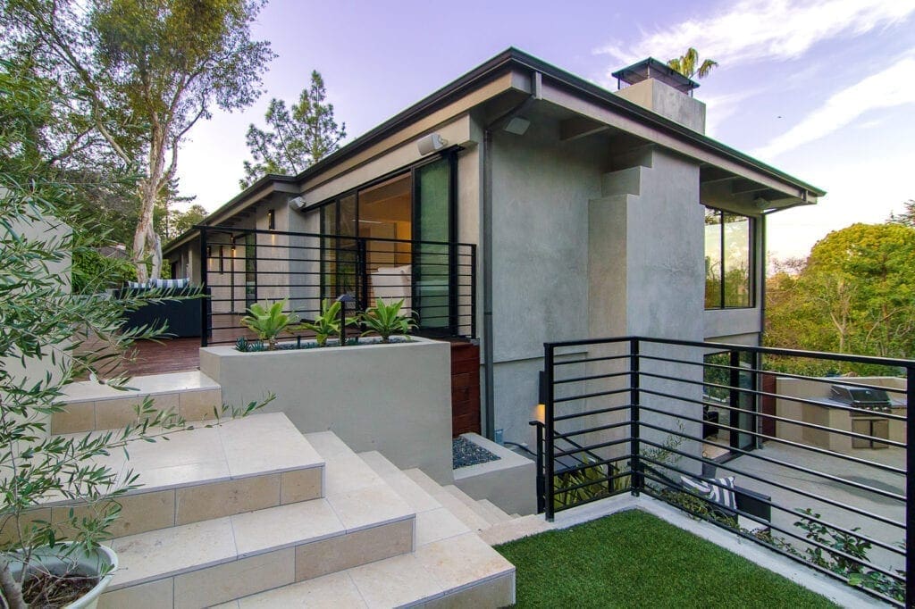 A house with steps leading to the front door.