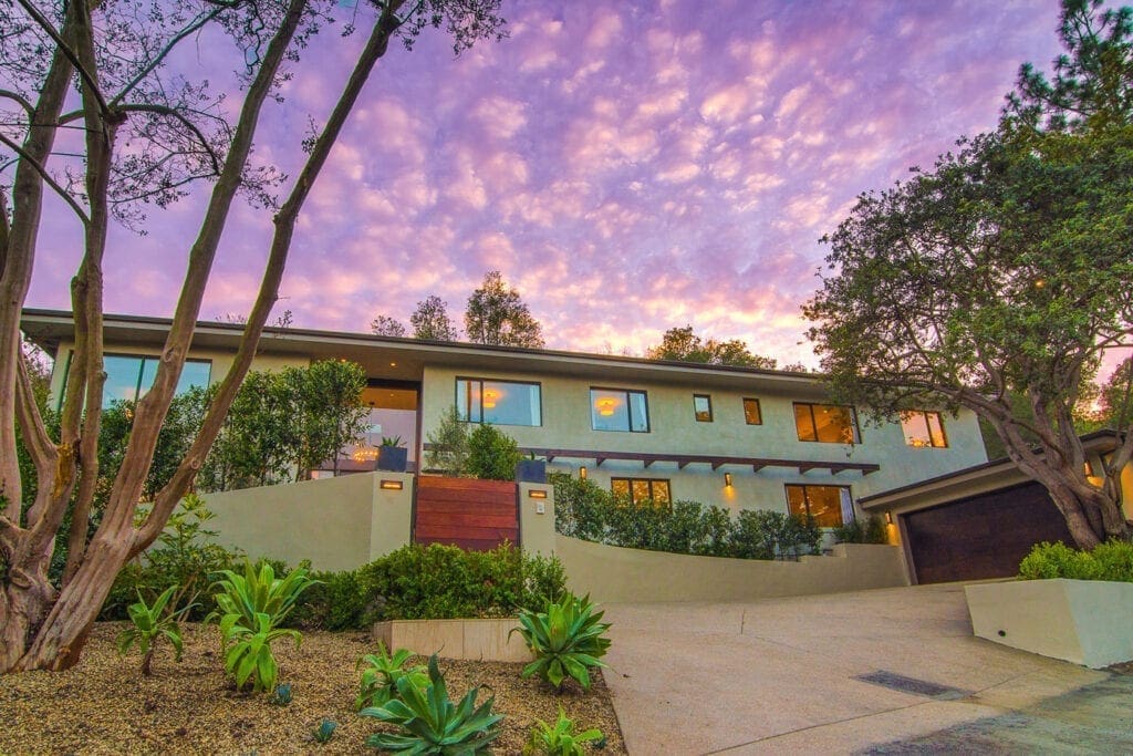 A building with a sky background and trees