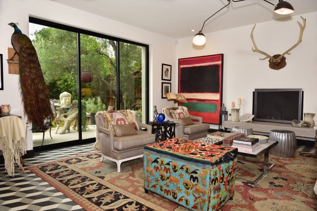 A living room with a couch, chair and television.