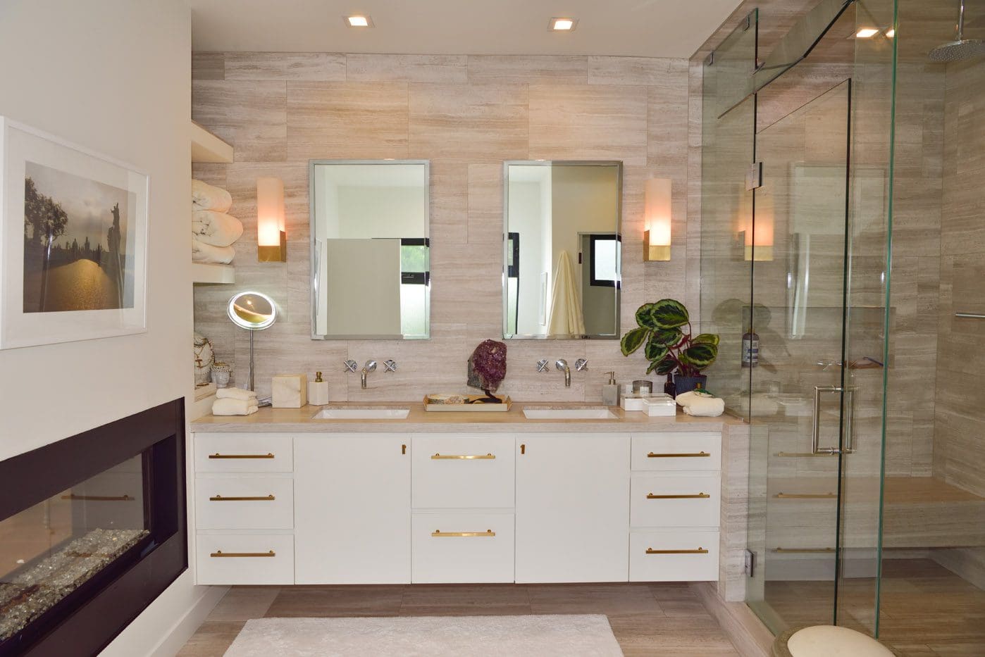 A bathroom with two sinks and a large mirror.