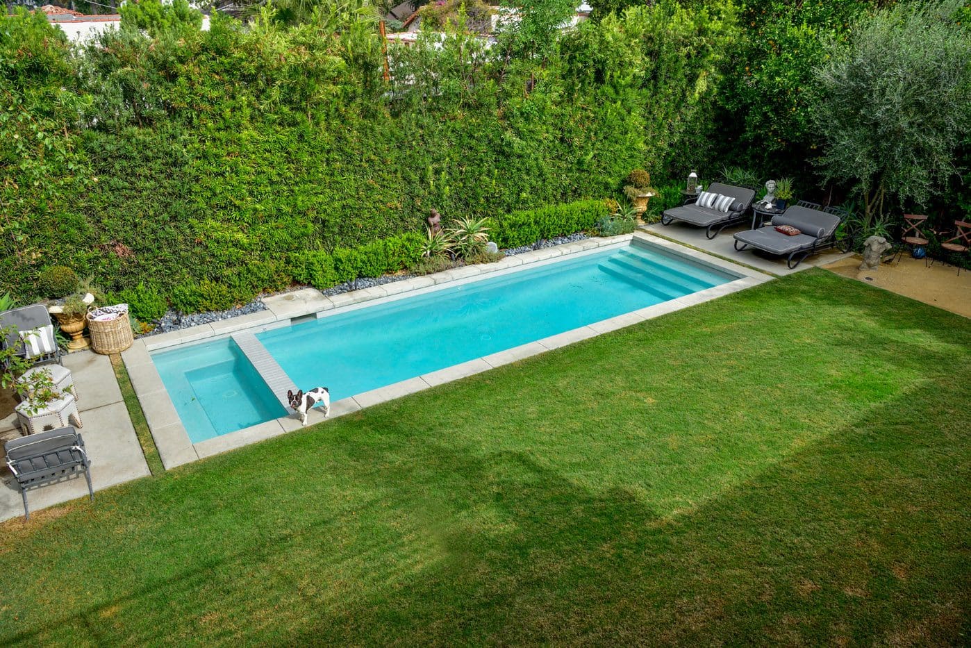 A pool that is in the middle of some grass.