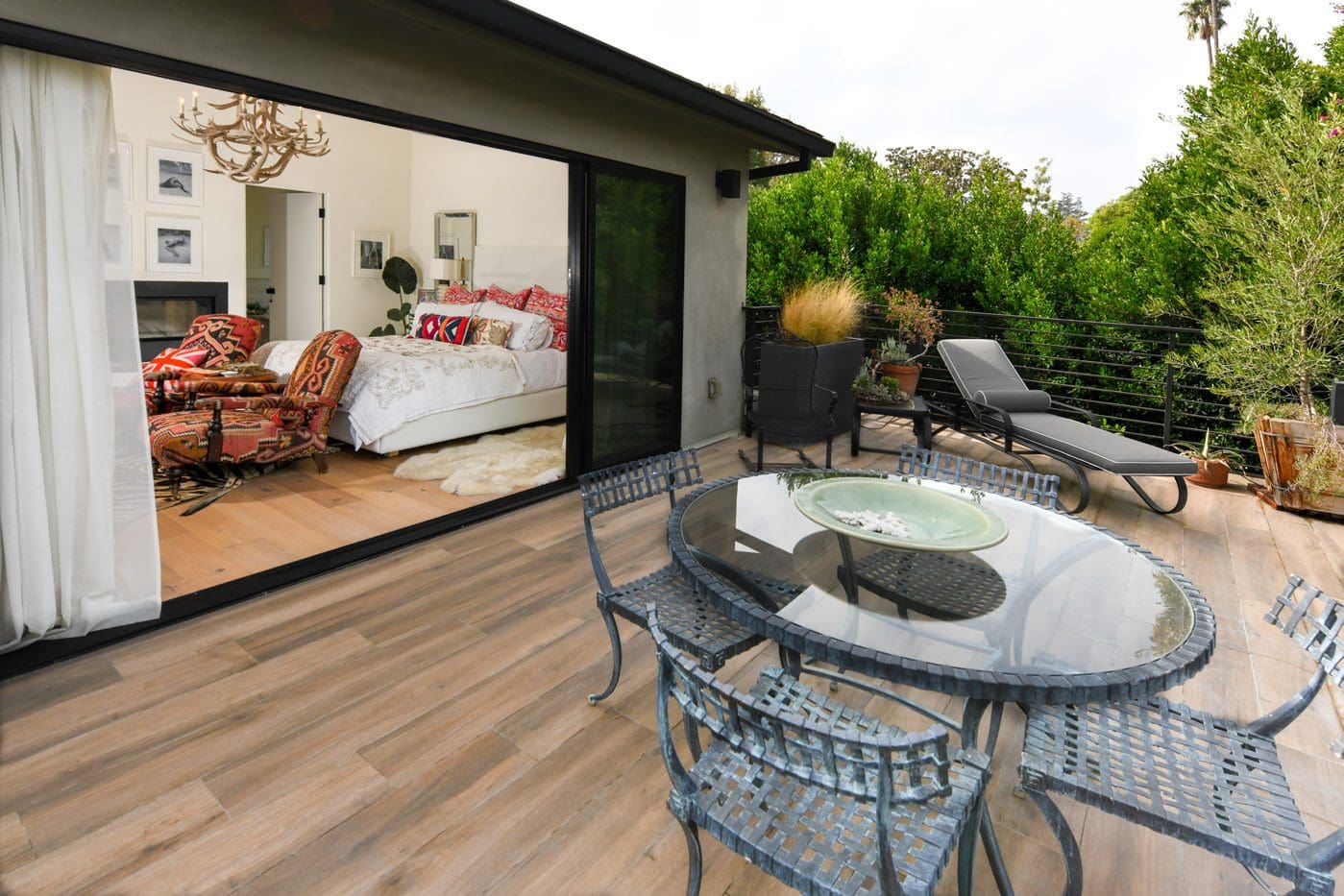 A patio with a glass table and chairs
