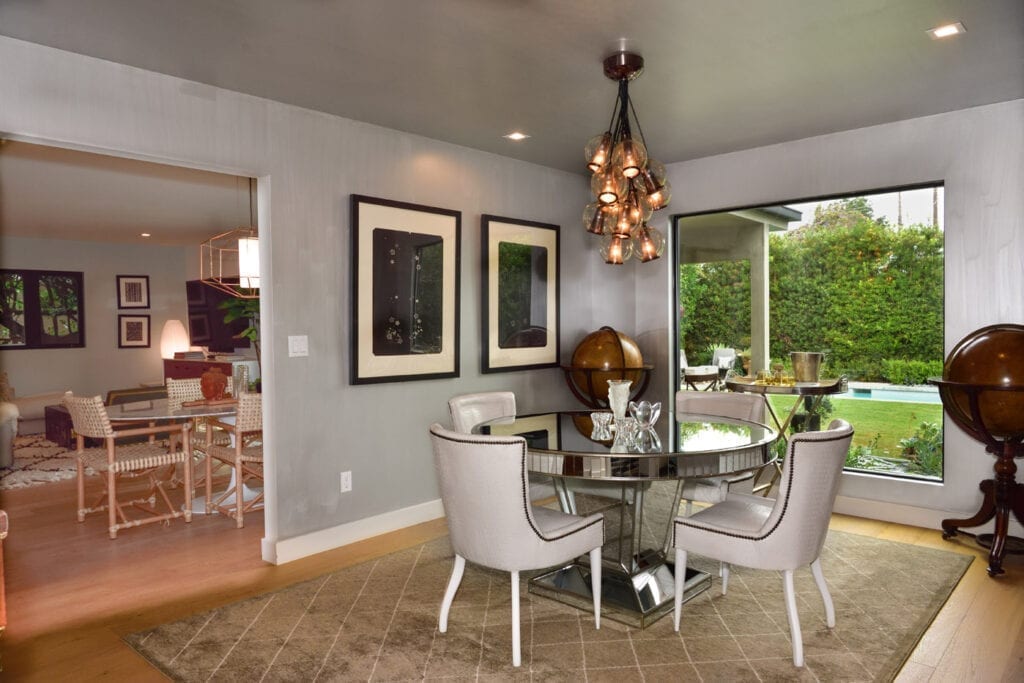 A dining room with a glass table and chairs