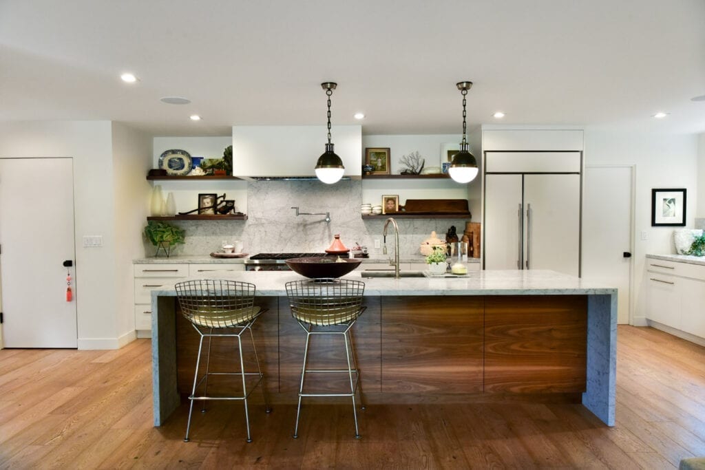 A kitchen with a large island and wooden cabinets.