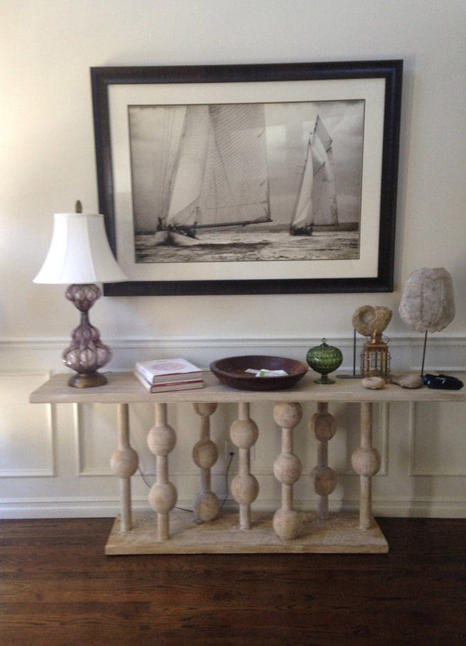 A table with lamps and a picture on the wall