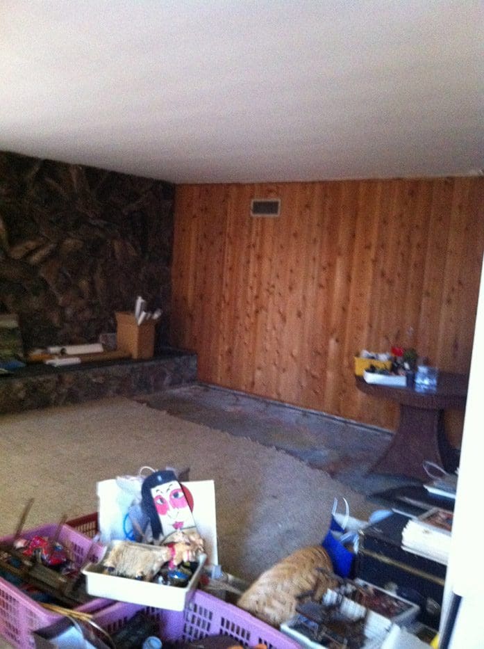 A room with wood paneling and a wall.
