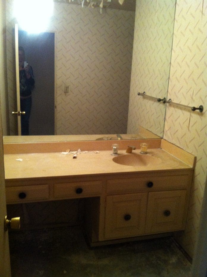 A bathroom with a sink and mirror in it