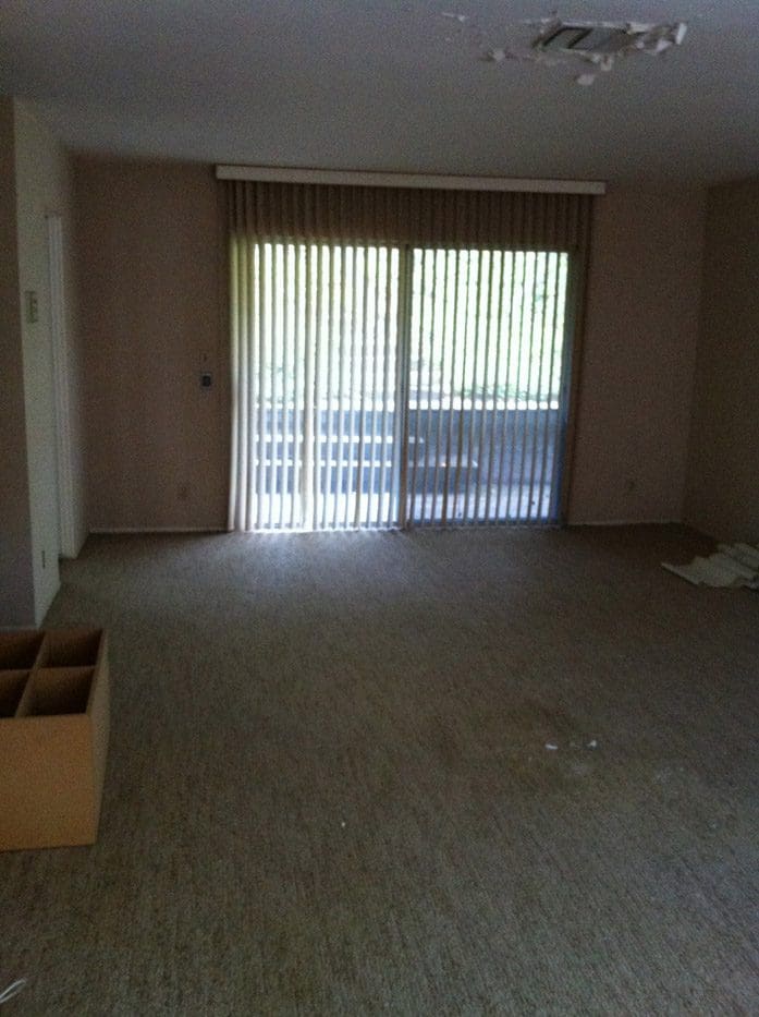 A room with a sliding glass door and a box.