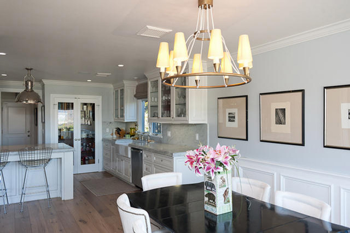 A dining room with a table and chairs, and a chandelier.