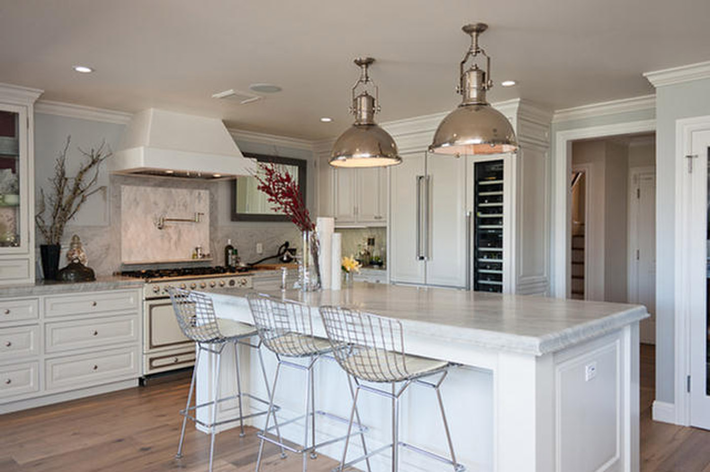 A kitchen with white cabinets and island in it