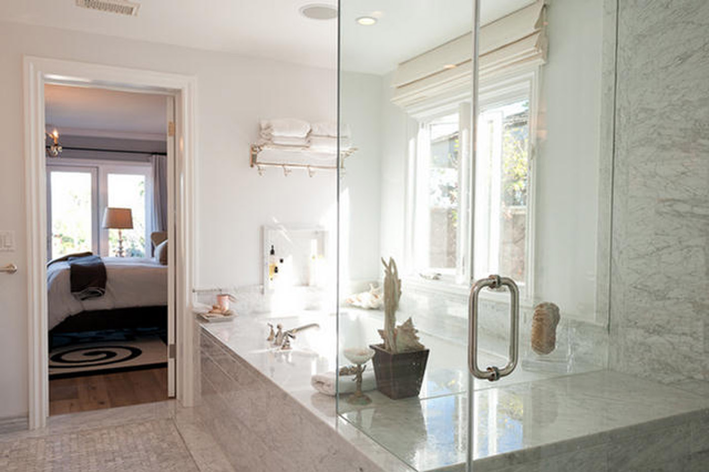 A bathroom with a large glass shower door.