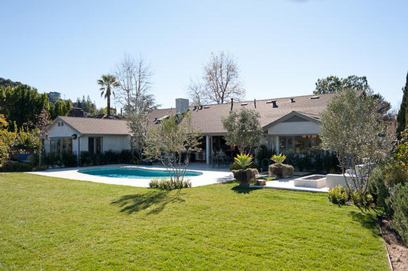 A large pool in the middle of a yard.