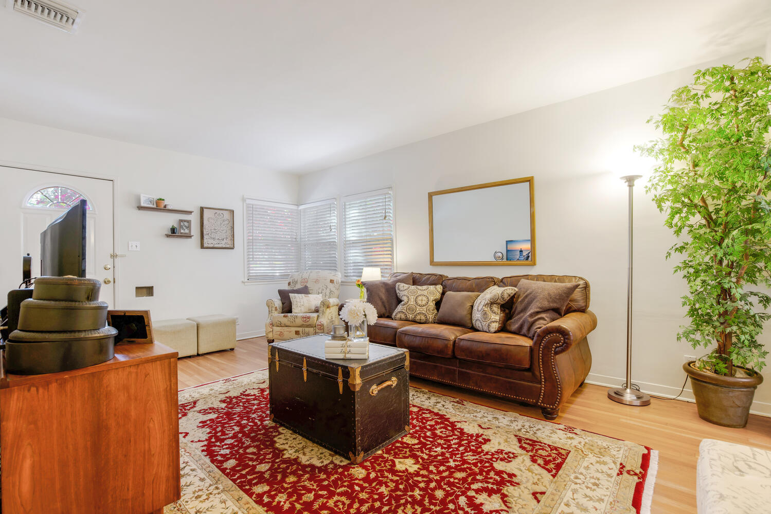 A living room with a couch, table and chair.