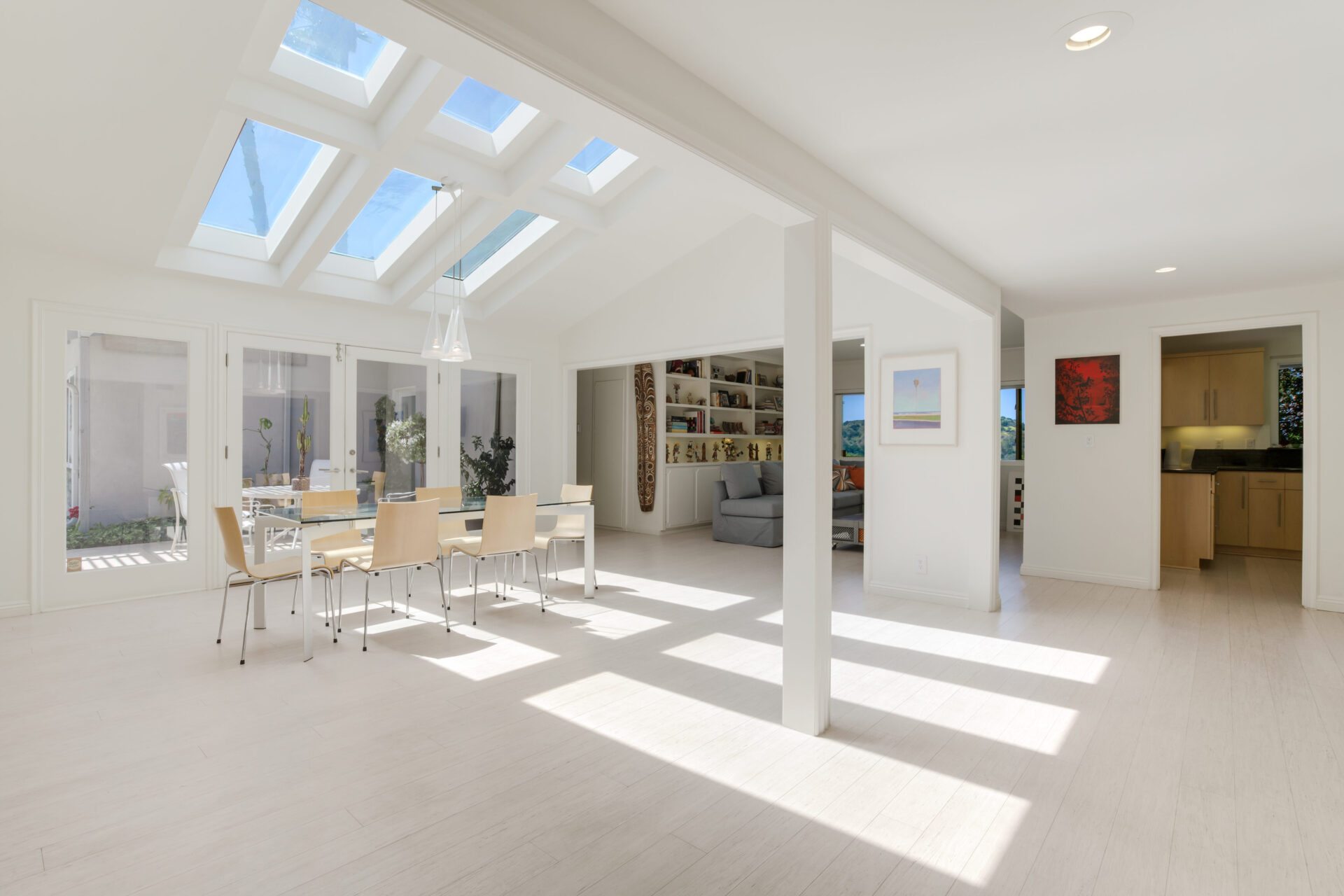 A room with white walls and skylights.