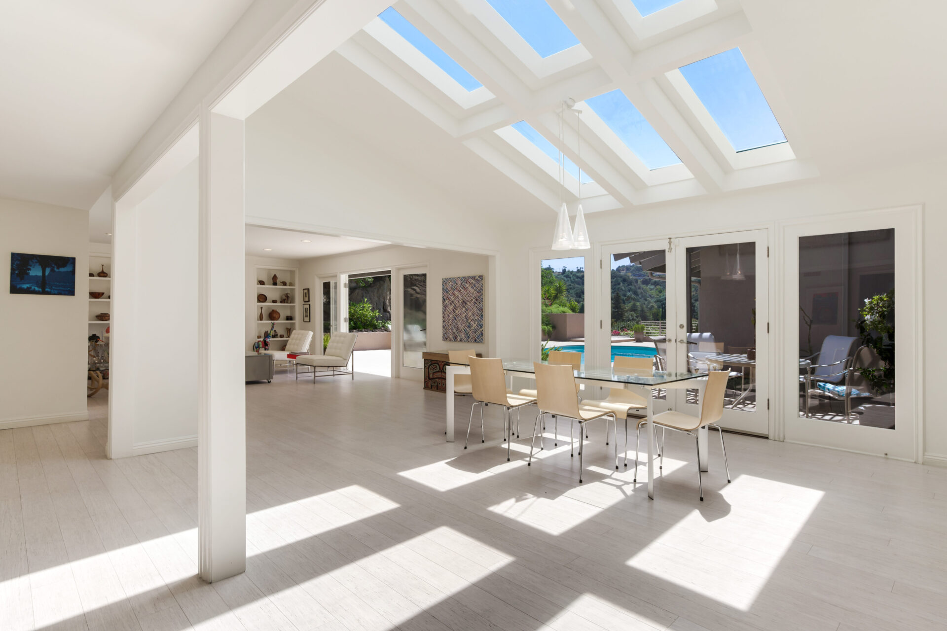 A large open room with skylights and glass windows.