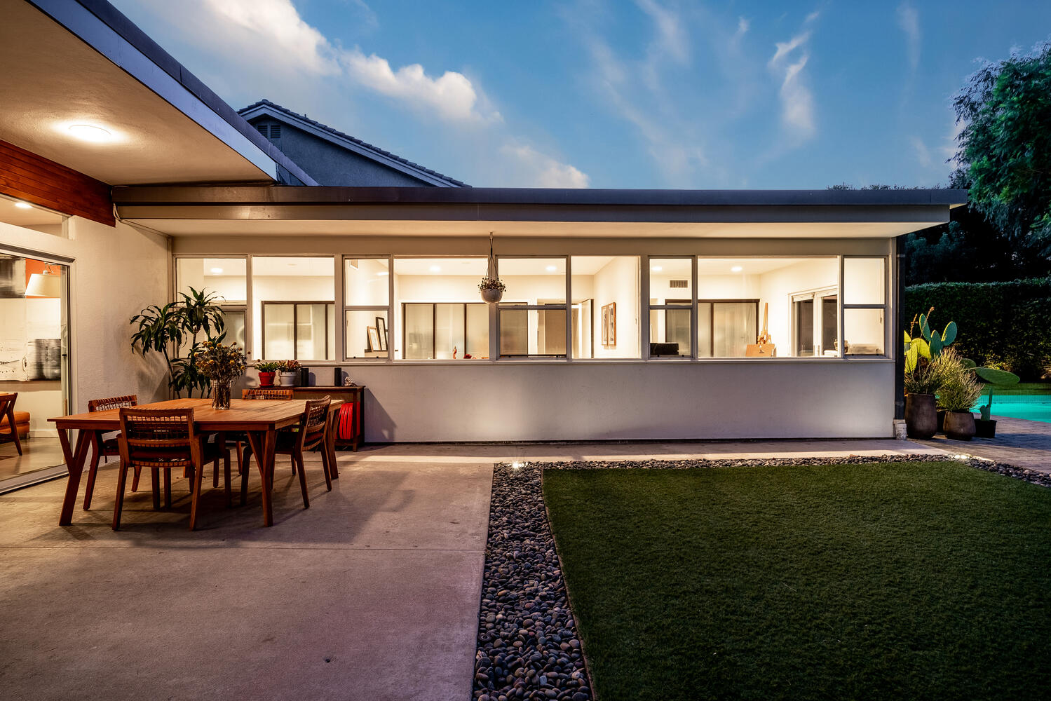 A patio with grass and lawn in the evening.