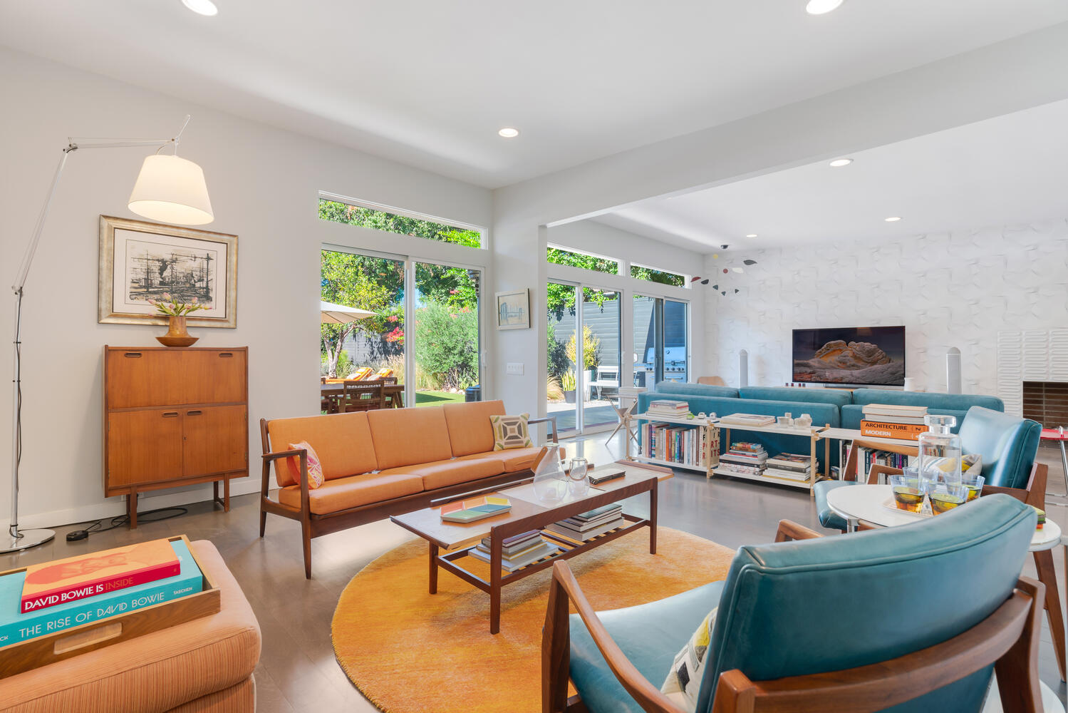 A living room with couches, chairs and tables.