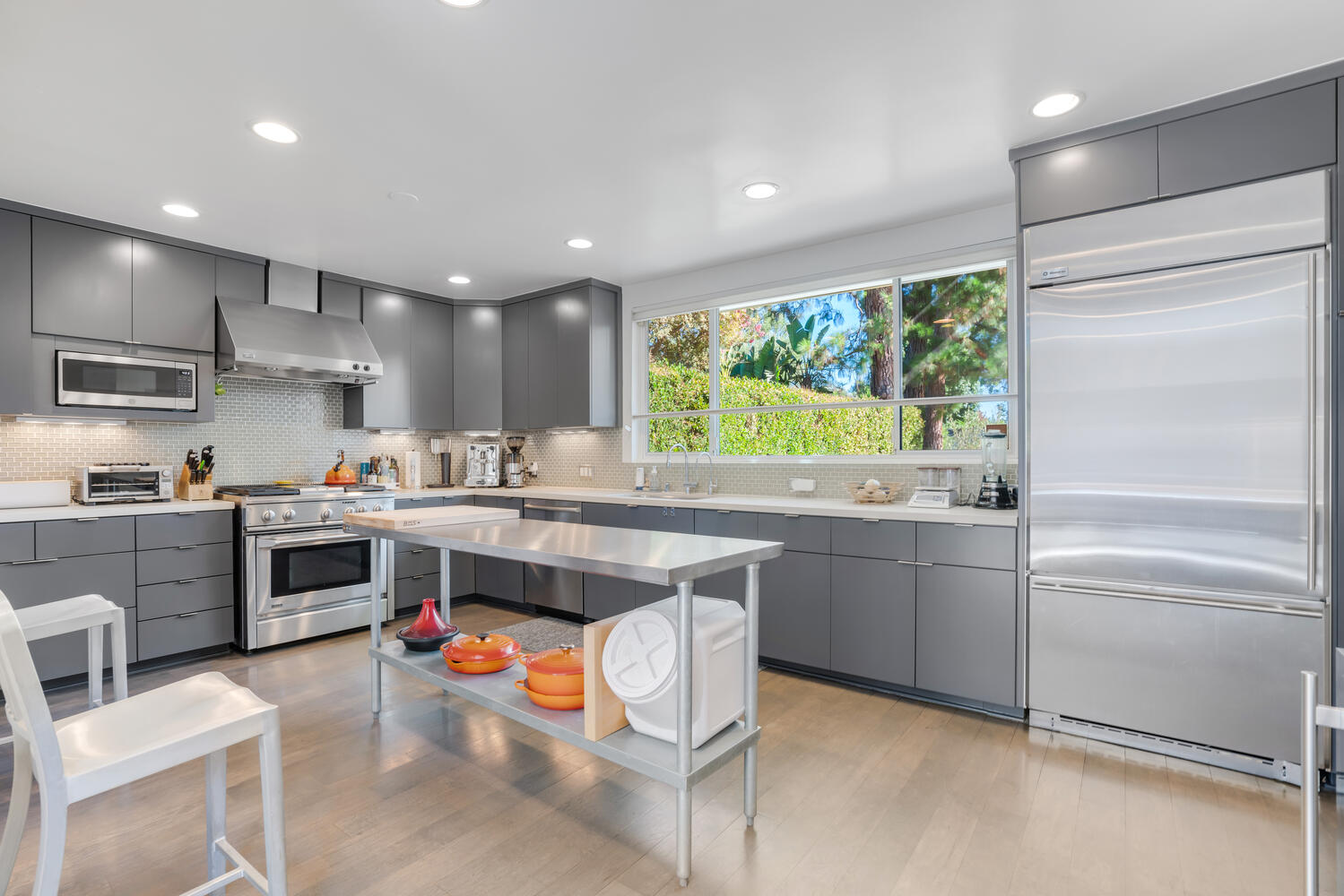 A kitchen with stainless steel cabinets and white appliances.