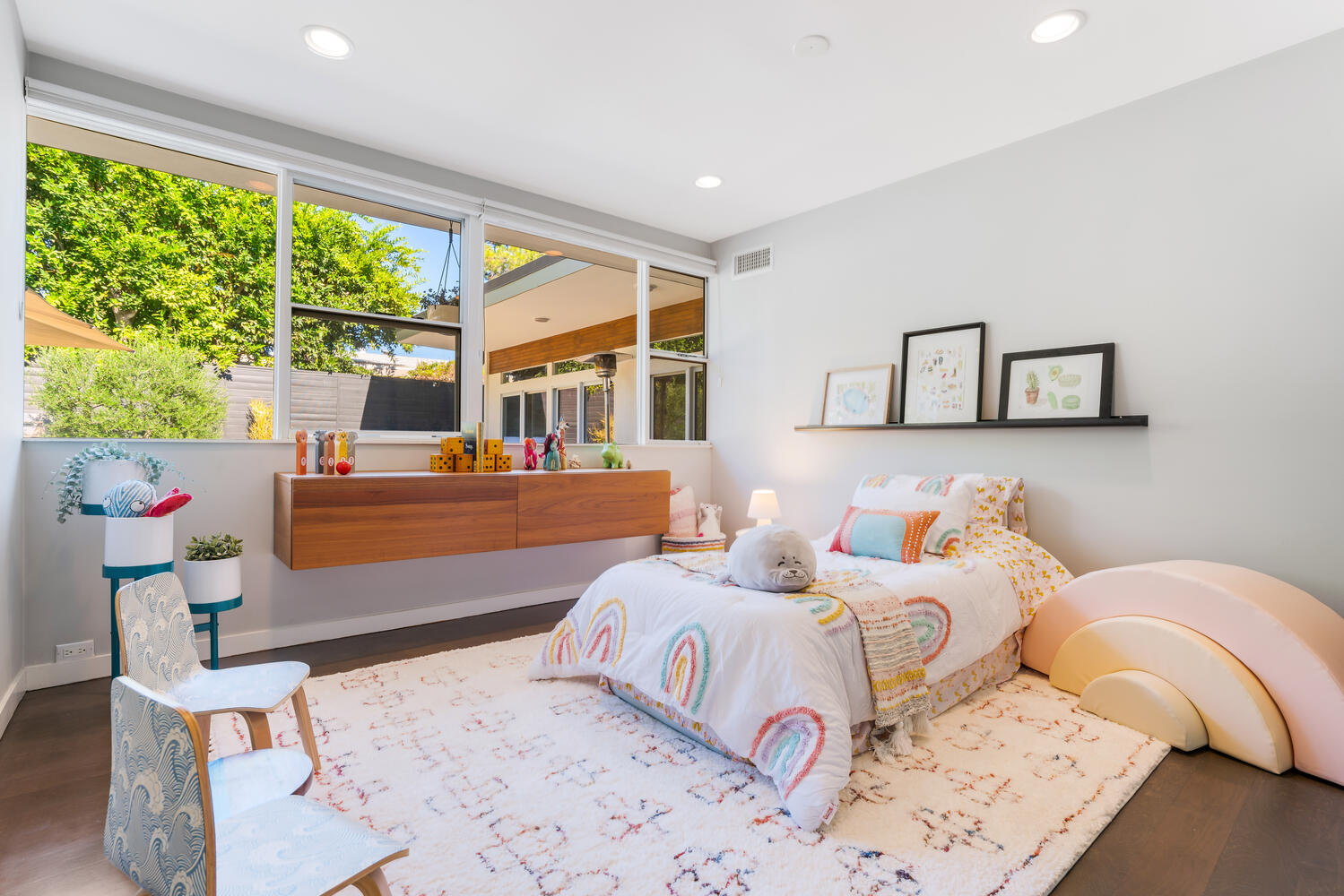 A bedroom with a bed, dresser and window.