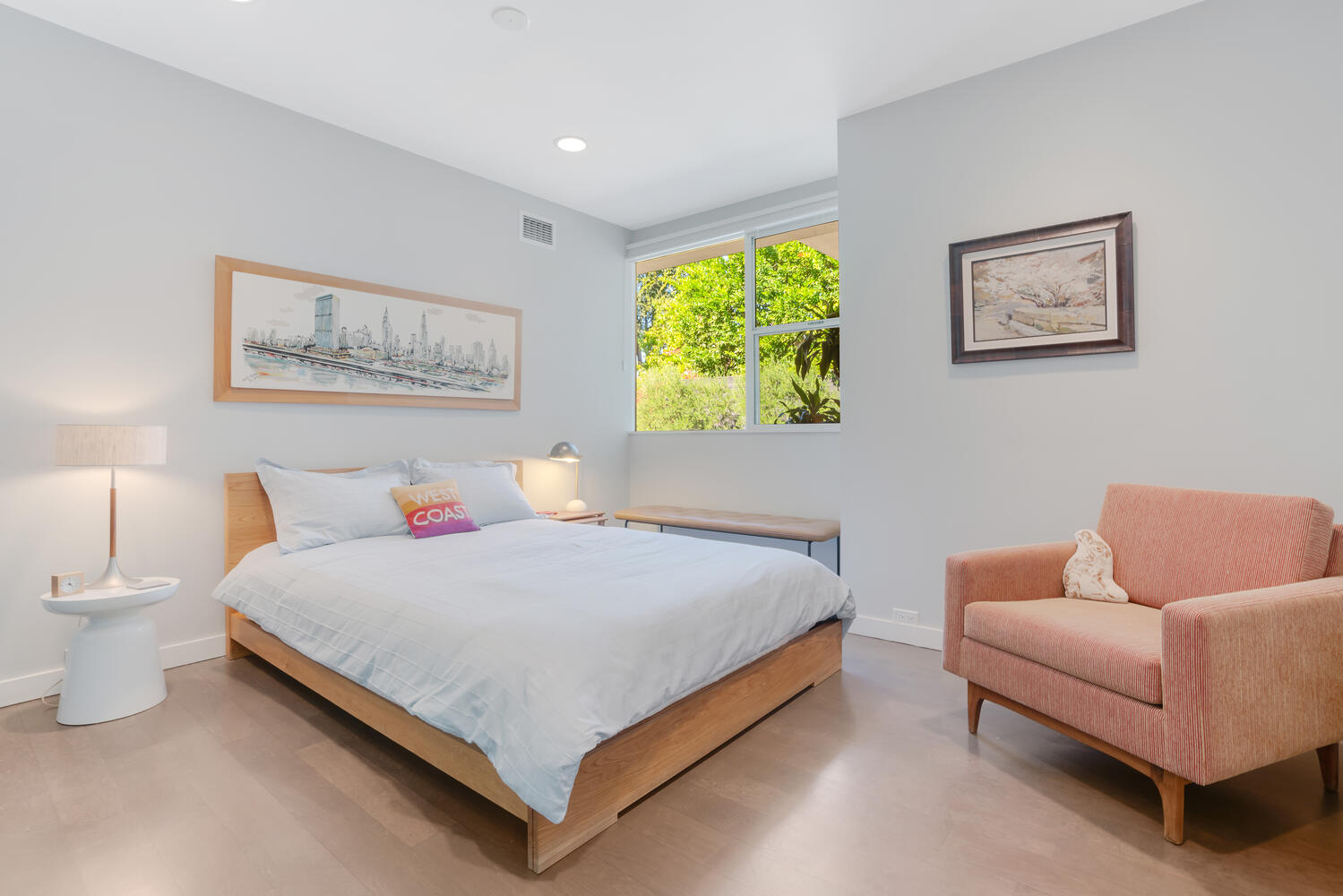 A bedroom with a bed, chair and window.