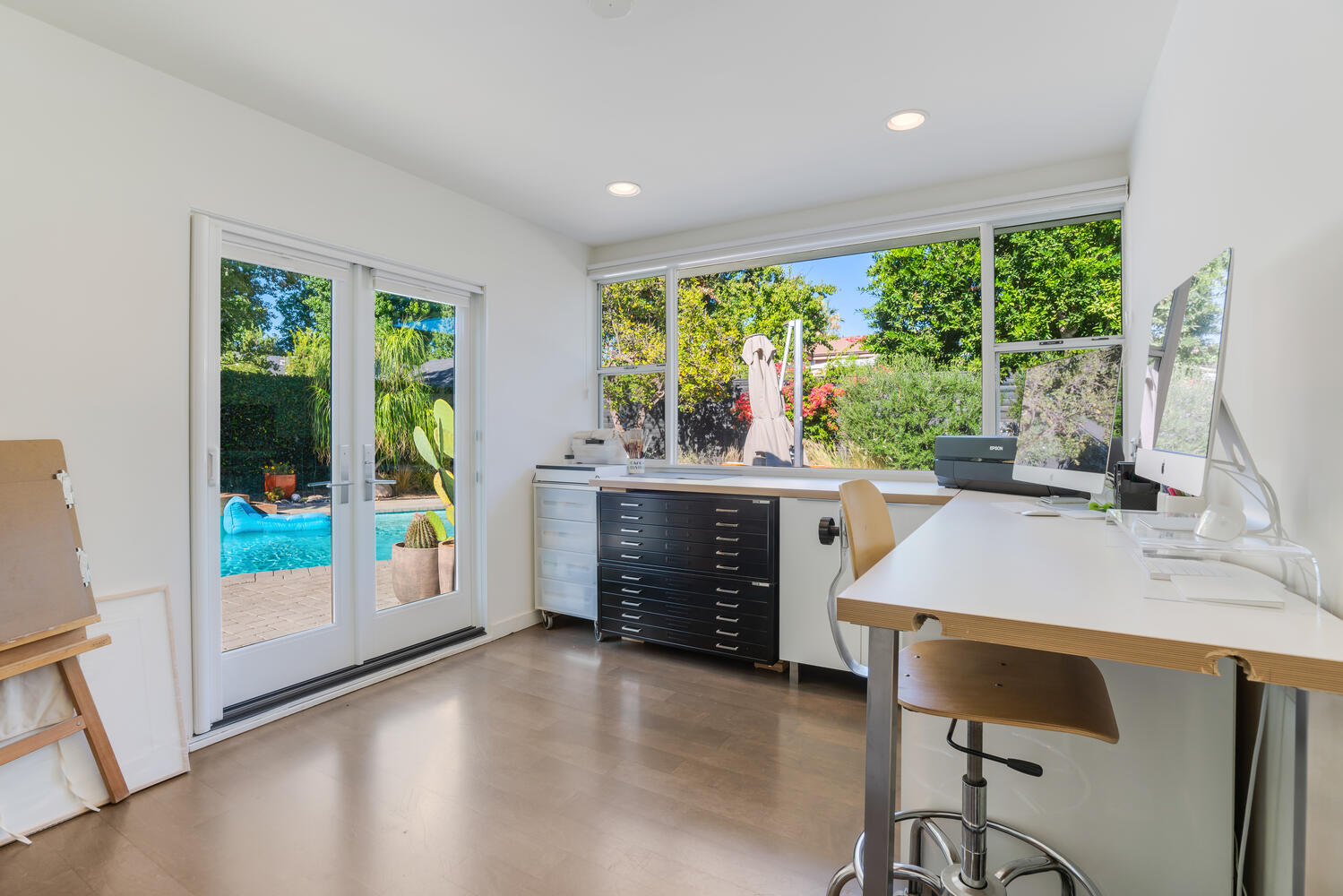 A kitchen with a pool and a large window.