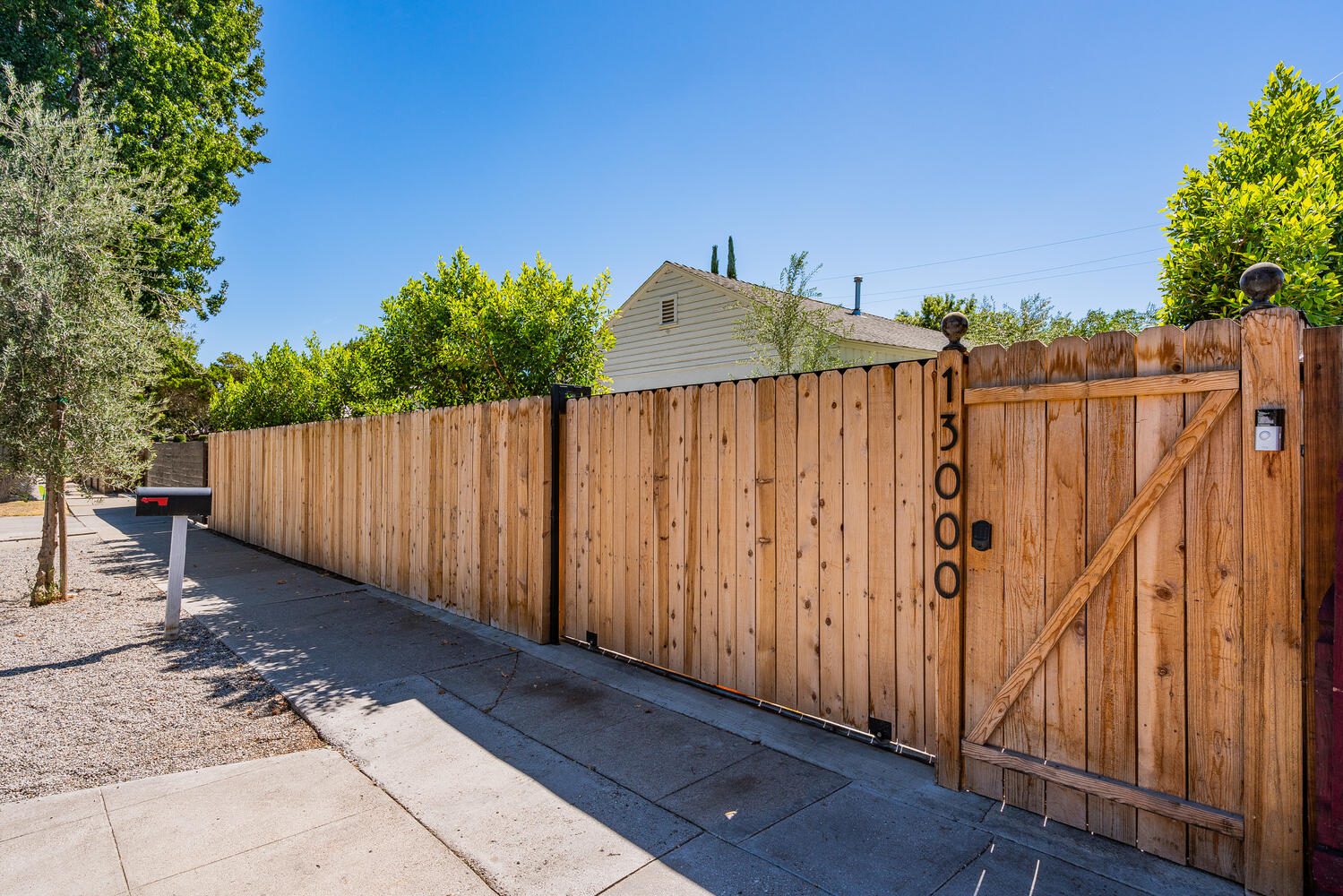 A wooden fence with trees in the background