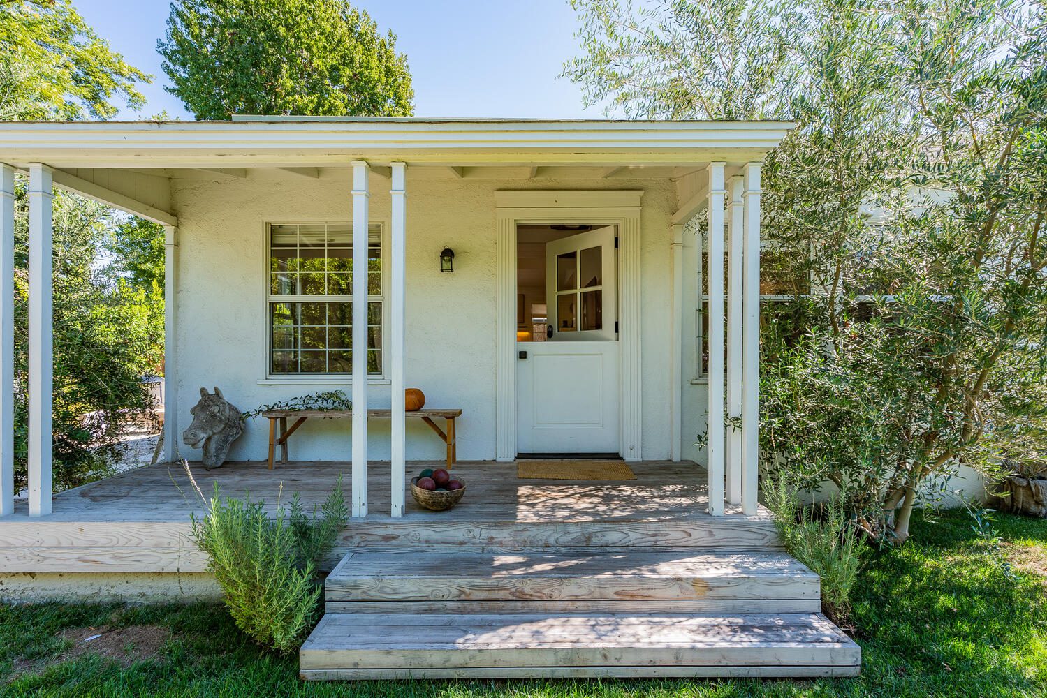 A porch with steps leading to the front door.