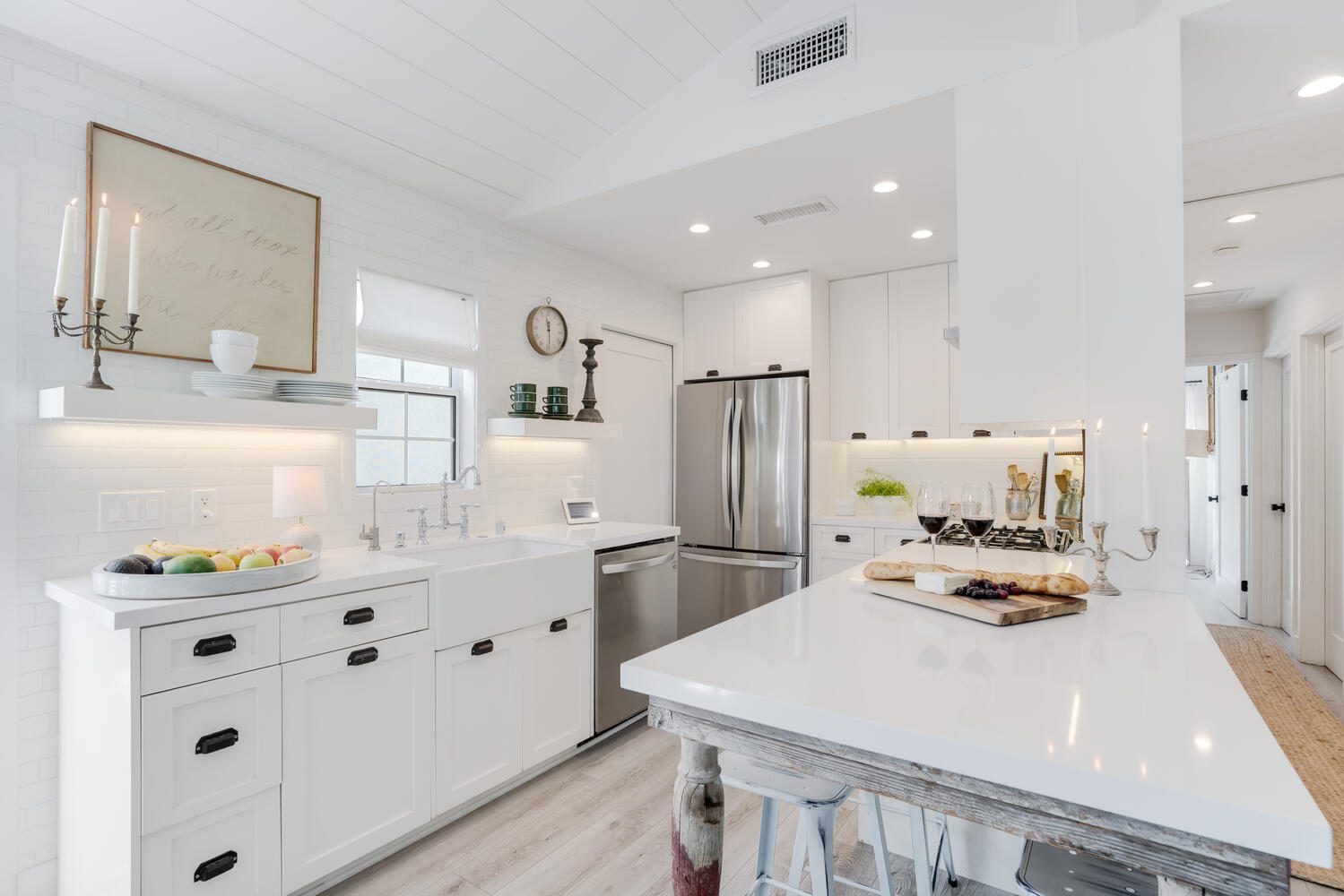 A kitchen with white cabinets and stainless steel appliances.