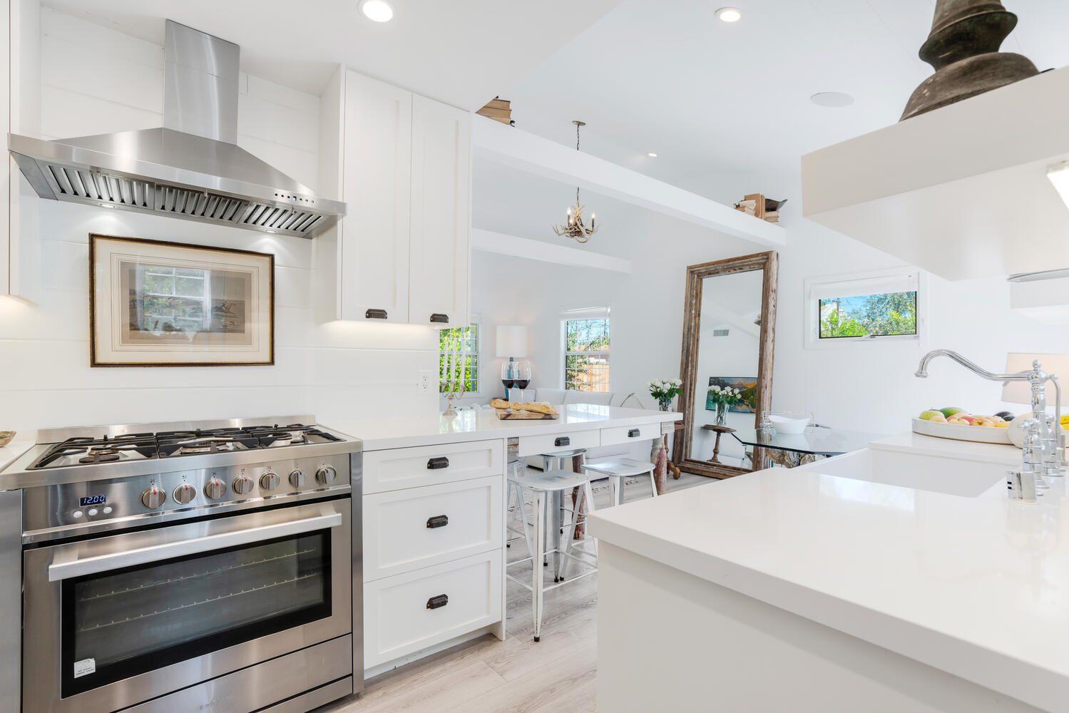 A kitchen with white cabinets and stainless steel appliances.