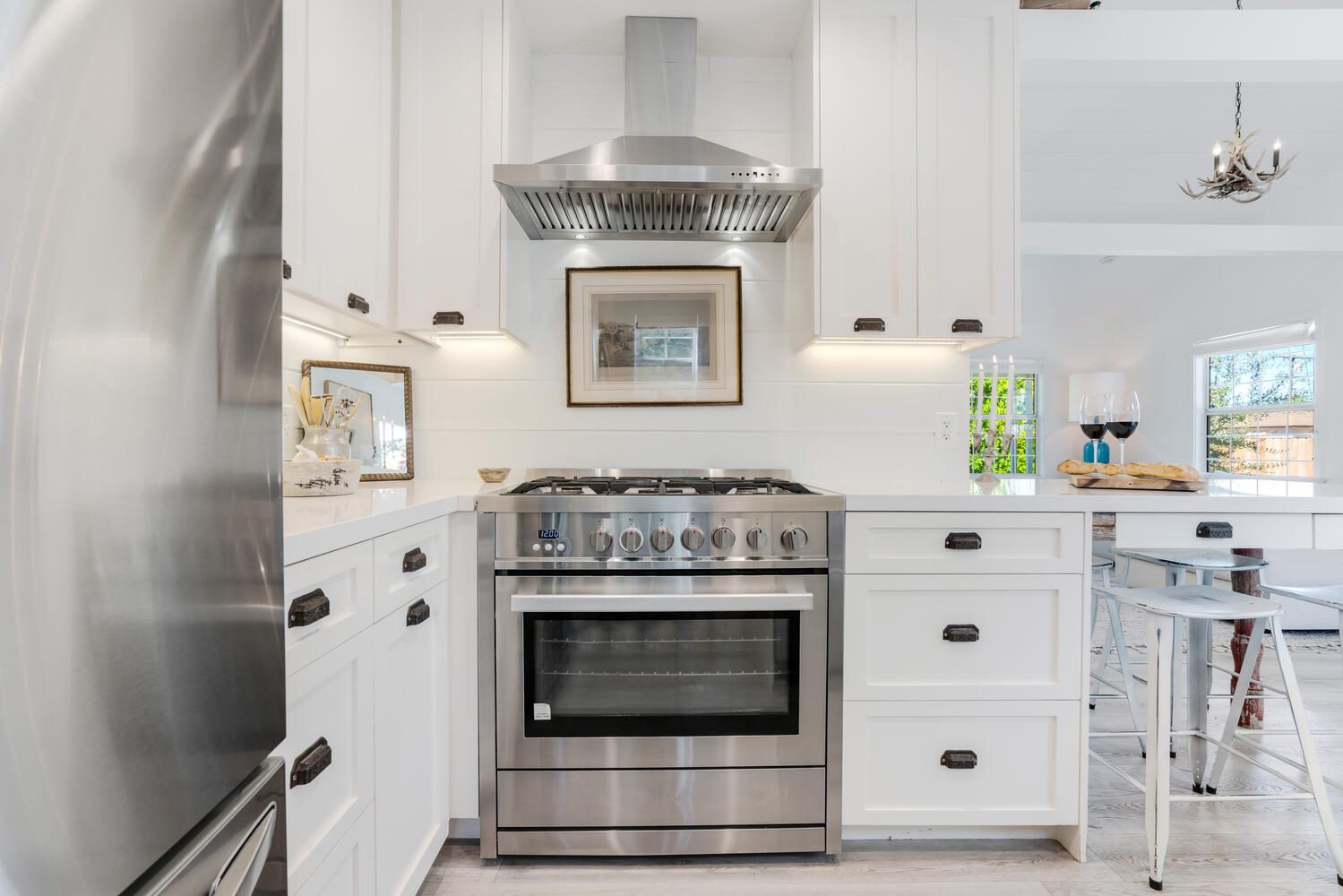 A kitchen with white cabinets and stainless steel appliances.