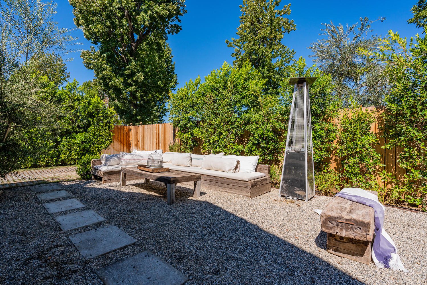 A backyard with a fire pit and patio furniture.