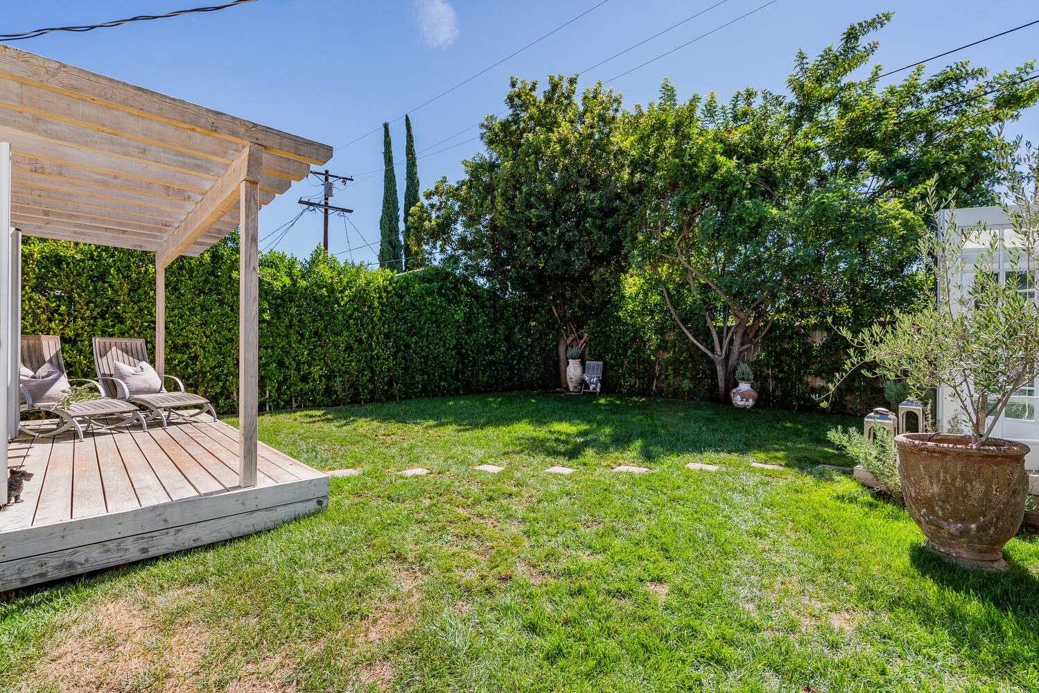 A backyard with a gazebo and lawn.