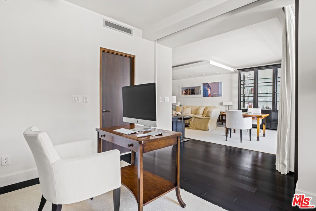 A living room with a desk and chair